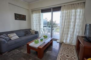 a living room with a couch and a coffee table at Karfas sea view apartment in Karfas