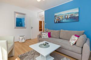 a living room with a couch and a table at Apartment Fiorella in Dubrovnik