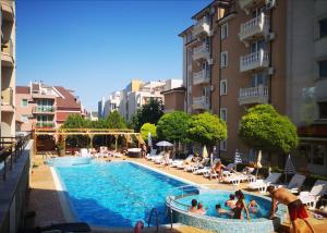 a large swimming pool in a city with people in it at Tropics Hotel - Ultra All Inclusive in Sveti Vlas