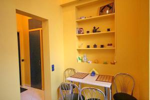 a kitchen with a table and chairs and a window at Park and Opera Apartments in Lviv