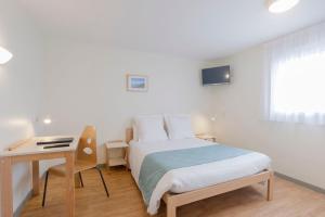a bedroom with a bed and a desk and a bed at Centre Jean XXIII in Annecy