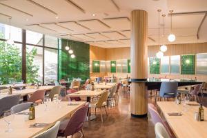 a restaurant with tables and chairs and large windows at Ciutat de Granollers in Granollers