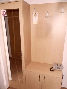 a phone sitting on top of a cabinet with a mirror at Sea Park Homes Neshkov in Varna City