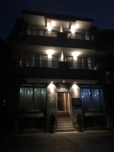 a building with lights on top of it at night at Vanilla Boutique Hotel in Skopje