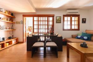 a living room with a table and a couch at Casa Pepa Agaete in Agaete