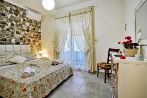 a bedroom with a bed and a desk and a window at Villa Zoi in Pelekas +53 photos