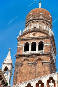 a building with a tower with a clock on it at Red House ai Mori in Venice