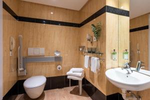 a bathroom with a sink and a toilet at Hotel San Sebastián Orly, Affiliated by Meliá in Donostia-San Sebastián
