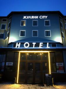 a hotel with a sign on the front of it at Zhuliany City Hotel in Kyiv