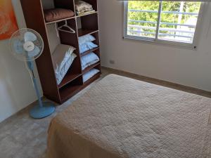 a room with a floor fan and a closet at Calle 3 1526 in Santa Teresita