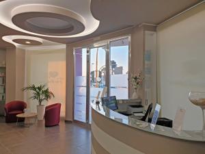 a lobby with a reception desk in a building at Travini Hotel Residence in Marsala