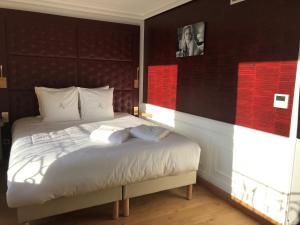 Postel nebo postele na pokoji v ubytování Hôtel Merveilleux Côté Mer