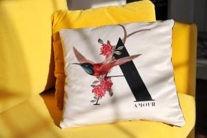 a pillow with a bird on it sitting on a chair at Apartament Dobre Miejsce in Ustrzyki Dolne