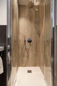 a shower with a glass door in a bathroom at VillaGiardino - Lake in Molveno
