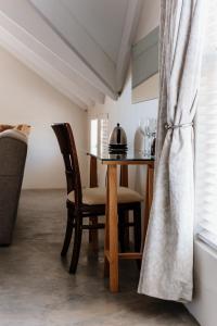 a dining room with a table and chairs at De Linden Boutique Guest House in Paternoster