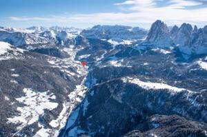 a person standing on top of a snowy mountain at La Tambra - Residence - Central with Restaurant in Santa Cristina Gherdëina