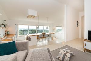 a living room with a couch and a kitchen at Sea View Cascais Design Villa in Alcabideche