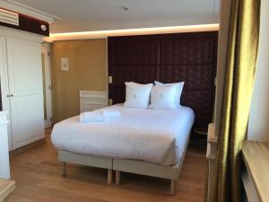 Postel nebo postele na pokoji v ubytování Hôtel Merveilleux Côté Mer
