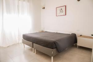 um quarto com uma cama num quarto branco em Torre 2 San Bonifacio - Locazione Turistica em San Bonifacio