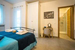 a bedroom with a bed and a table and a chair at Valle dei Mulini - Lake Como in Bellano