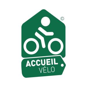 a green sign with a person riding a motorcycle at Hôtel de l'Ours in Arette