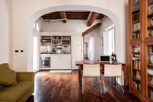 a kitchen and dining room with a table and chairs at CozyStay - Apt, One-bed apt & Rooms in Pisa +53 photos