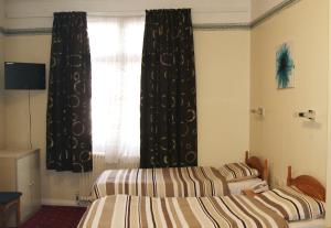 Postel nebo postele na pokoji v ubytování Stanley House Hotel