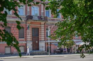 a person walking on a street in front of a building at Sodu15 Apartments in Vilnius