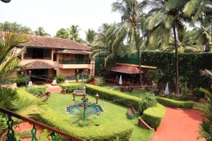 a resort with a garden with a pool and trees at Casa Severina in Calangute