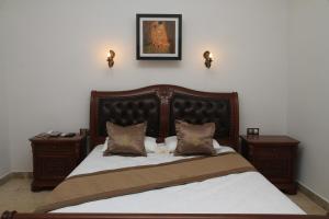 a bedroom with a large bed with two night stands at Cesme Kanuni Kervansaray Historical Hotel in Çeşme