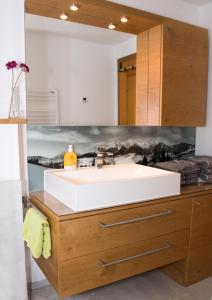 a bathroom with a white sink and a mirror at Ferienhaus Gasteg in Maria Alm am Steinernen Meer