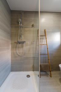 a bathroom with a shower with a glass door at Carmo Apartments in Lisbon
