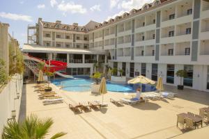 a large hotel with a pool and a slide at Dalaman Airport Lykia Thermal & Spa Hotel in Dalaman