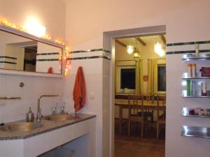 a bathroom with two sinks and a dining room at Hof-Solgaard in Loit