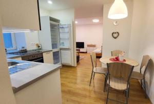 a kitchen and dining room with a table and chairs at apartmán U Moravy in Olomouc