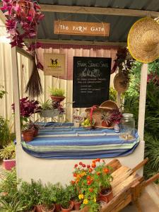 a flower stand with potted plants and a sign at Moonriver Lodge in Cameron Highlands