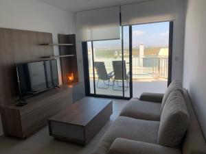 un soggiorno con divano e TV a schermo piatto di Mar y Sol a Gran Alacant