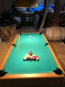 a pool table with balls on top of it at 2 Chez Tabuteau in Tabuteau