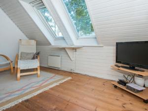 a living room with a flat screen tv and a window at Holiday Home Lyngvejen IV in Rømø Kirkeby