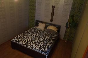 a bed with a zebra print sheets and pillows at Always at home - Apartments №2 at Klimasenko 11 block 7 in Novokuznetsk