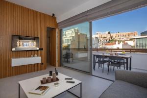a living room with a couch and a table at Acropolis Golden Suites by GHH in Athens