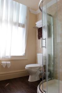 a bathroom with a toilet and a glass shower at Smith And Western in Royal Tunbridge Wells