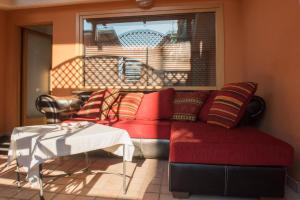 a living room with a red couch and a table at Villa Alba Boutique Hotel in Pescara