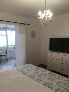 a bedroom with a bed and a flat screen tv at Chambres d'hôtes Le Mont d'Anon in Goviller