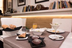 a table with plates of food and drinks on it at Villa Alba Boutique Hotel in Pescara
