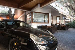 a black car parked in front of a restaurant at Villa Alba Boutique Hotel in Pescara