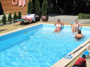 un grupo de personas sentadas en una piscina en Guesthouse Ursula, en Čakovec