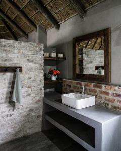 a bathroom with a white sink and a mirror at Breathe River Retreat in Parys