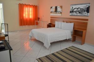 Llit o llits en una habitació de Calabreza Hotel e Restaurante - By UP Hotel
