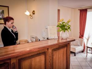 une femme parlant au téléphone dans un salon de coiffure dans l'établissement Hotel Koloseum, à Turek